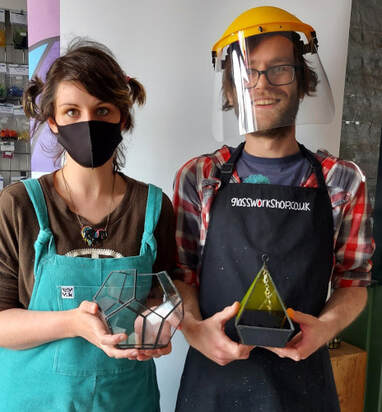 Couple enjoying a stained glass workshop
